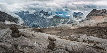 Stones cairn bridging on Zugspitze peak, Alps, Germanyの写真素材