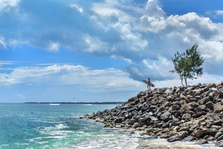 Woman with a surf board ready to surfの写真素材