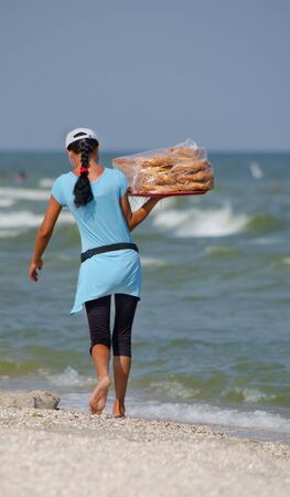 Woman - the seller, by the sea is a tray of baklavaのeditorial素材
