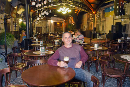 Man drinking coffee in a cafe in Lviv, Ukraineのeditorial素材