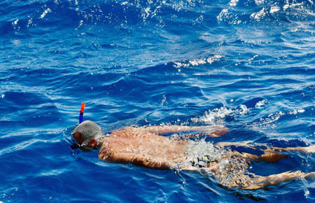 A man swims in the Red Sea and snorkelling. Travel, Egypt.の写真素材