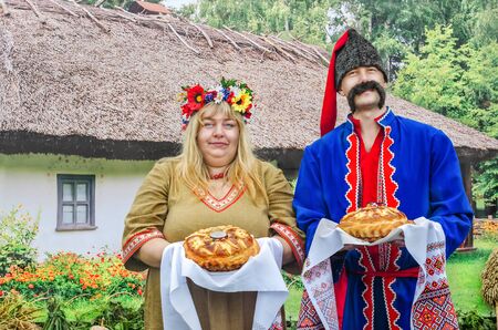 Hospitable man and woman in the Ukrainian national costumesのeditorial素材