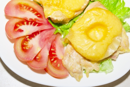 Chicken with pineapple, tomato and lettuceの写真素材