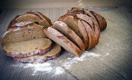 Fresh Tasty Bread on Woody Background