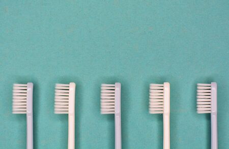 Clean toothbrushes laid out on background for inscription text about oral hygiene.の写真素材