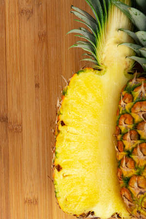 Yellow Ripe ripe pineapple on wooden background.の写真素材