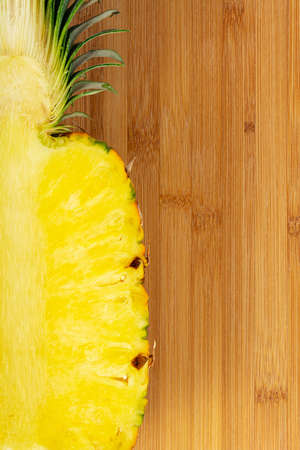 Yellow Ripe ripe pineapple on wooden background.の写真素材