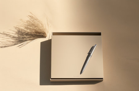 an empty paper box, pen, pens, and a notebook.の素材