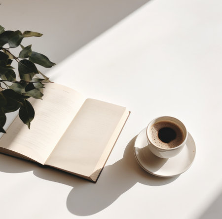 coffee and a book on a white table.の素材