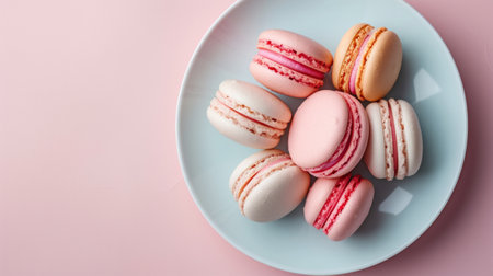 A minimalist composition of pastel-colored macarons on a white plate.の素材