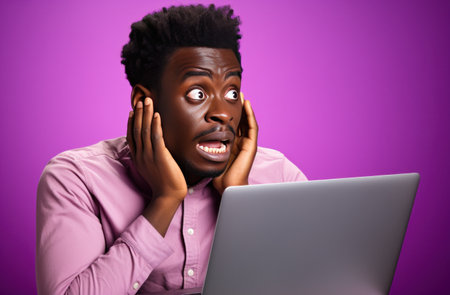 human being looking at laptop holding up in front of purple background that appears on a pink,の素材