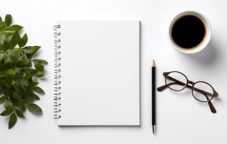 a coffee cup, notebook, and glasses next to a blank page.の素材