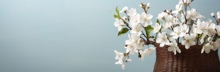 white easter basket with flowers in the vase.の素材