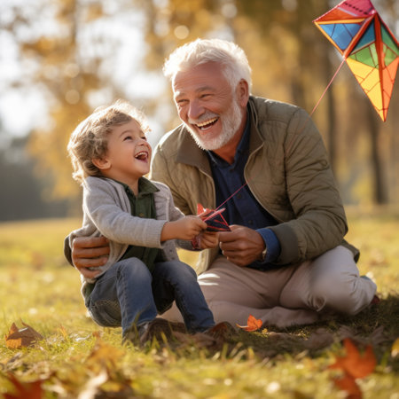 An older man and his grandson fly a kite together in a park,.の素材