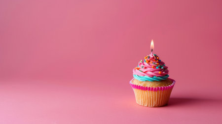 birthday vivid background with cupcake with candle on pink.の素材
