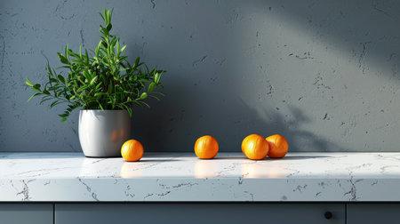 Three oranges placed on a counter next to a potted plant indoors.の素材