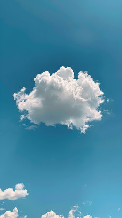 A blue sky filled with fluffy white clouds, with a commercial airplane soaring through the air. The plane leaves a thin trail in its wake as it moves across the sky.の素材