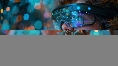 A man wearing a pair of virtual reality glasses, immersed in a digital environment. The glasses are connected to a computer, and the man appears focused on the virtual world he sees through them. His hands might be interacting with virtual objects or controls.の素材