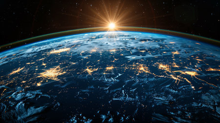 The sun shines brightly over the Earth in this space view, illuminating the planets surface with its warm light. The Earth appears as a small blue and green sphere against the vast darkness of space.の素材