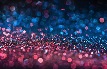 Blurry pink and blue lights creating a colorful and dynamic visual effect. The lights appear to be moving or shimmering, casting a soft glow in the surrounding space.の素材