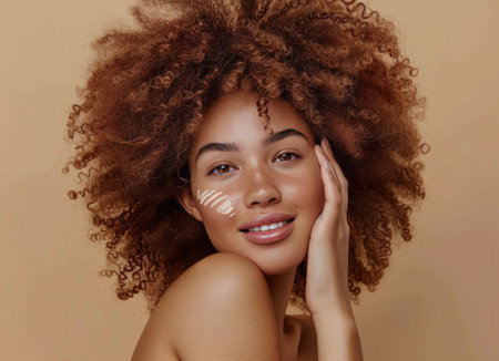 A woman with curly hair is striking a pose for a photo. She is looking directly at the camera, with a confident expression on her face. Her curly hair frames her features beautifully, adding a dynamic element to the shot.の素材