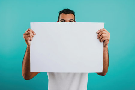 man holding up a blank paper.の素材