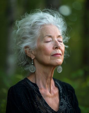 An older woman with white hair wearing earrings.の素材