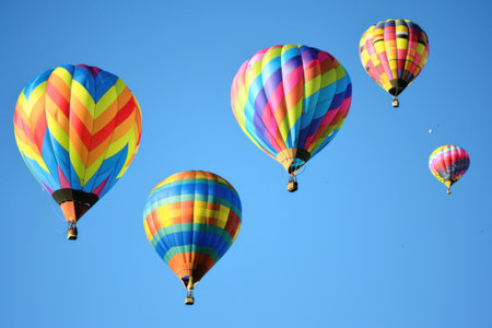 Hot Air Balloon Adventure. Colorful balloons soaring against a clear sky.の素材