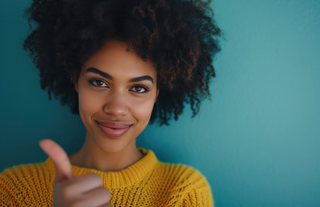 beautiful african american woman with a afro showing her thumb.の素材