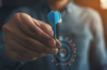A person is holding a blue toothbrush in their hand, ready to brush their teeth. The hand grips the toothbrush firmly, displaying a daily oral hygiene routine.の素材