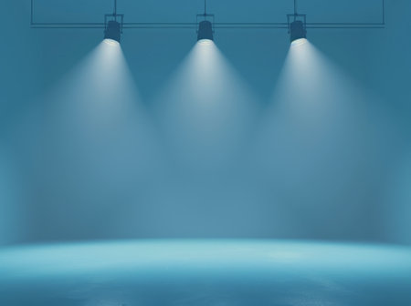 Three bright spotlights shine on a deep blue backdrop, creating a striking contrast between light and darkness.の素材