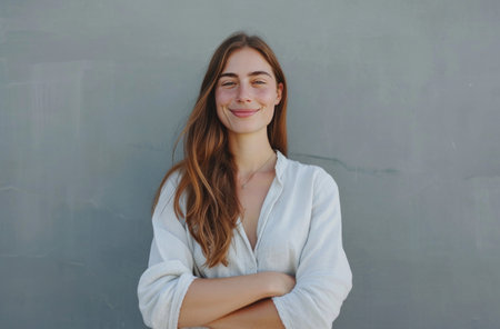 happy woman standing with arms folded.の素材