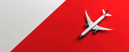 A white and red airplane stands out against a red and white background.の素材