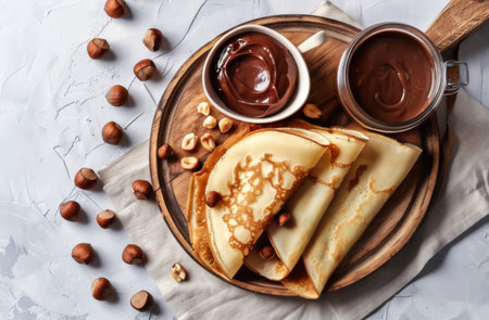 A plate of freshly made pancakes topped with a generous amount of nuts and decadent chocolate sauce.の素材