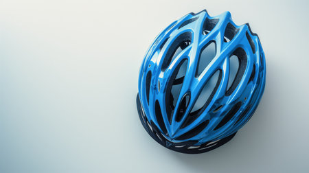 A blue bicycle helmet hangs on a wall, ready to be used for safe biking adventures.の素材