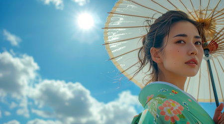 A woman in a traditional Japanese kimono smiles under a blue sky with a bright white cloud.の素材