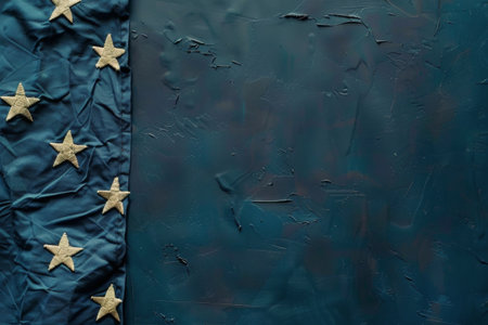 A close-up shot of a textured blue fabric with gold stars. The background is out of focus.の素材