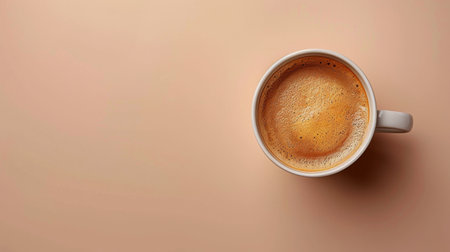 A cup filled with coffee sits atop a wooden table.の素材