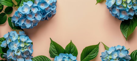 A close-up image of blue hydrangea flowers with green leaves on a tan background.の素材