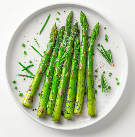 A plate of roasted asparagus spears seasoned with salt, pepper, and herbs.の素材