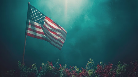 A US flag waving in the wind against a teal sky with plants in the foreground.の素材