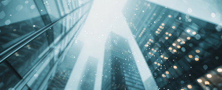 A blurred cityscape is reflected in the windows of a modern office building, with sunlight illuminating the scene.の素材