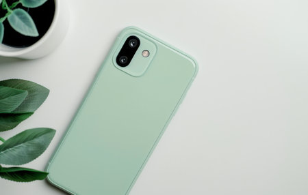 A close-up of the camera lens and charging port on a green smartphone.の素材