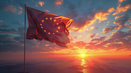 European flag flying in front of a vibrant sunset, showing colors of patriotism and unity.の素材