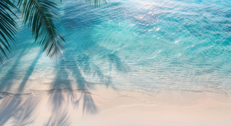 Crystal clear waters lap against the sandy beach, casting reflections from palm trees along the shoreline. The tranquil atmosphere captures the beauty of a peaceful morning by the sea.の素材