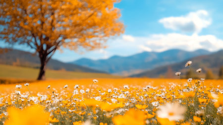 A vast field of vibrant yellow flowers stretches across the landscape, with a solitary tree standing against a backdrop of fluffy clouds and a bright blue sky, creating a tranquil and picturesque scene.の素材