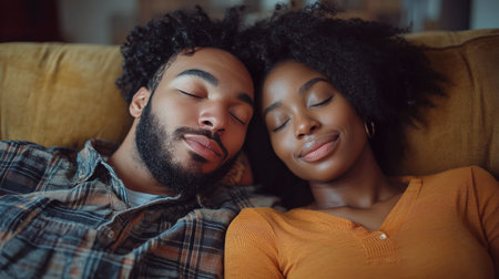 A couple is peacefully resting on a couch, enjoying each other's company. They wear matching sweaters, exuding warmth and affection as they share a quiet moment in a cozy, dimly lit room.の素材