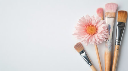 A delicate pink flower rests on a soft, neutral background, showing its vibrant petals and lush green leaf, creating a serene and calming atmosphere ideal for springtime decorations.の素材
