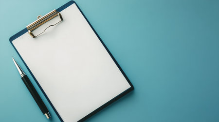 A blank clipboard sits next to a pen on a blue background, suggesting preparation for note-taking, planning, or brainstorming activities. The clean design emphasizes simplicity and functionality.の素材