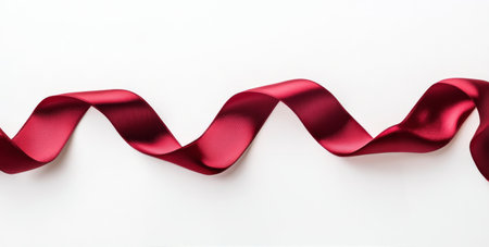 A vibrant red ribbon flows smoothly, displaying its glossy texture against a clean white backdrop, creating a sense of elegance and simplicity that captivates the viewers attention.の素材